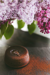 Classic chocolate fondant on a dark background with flowers