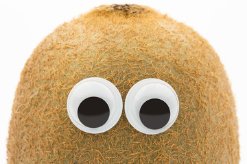 kiwi face with googly eyes on white background 