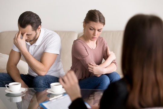 Trusted family relationships expert working with young couple after quarrel not talking to each other, helping to understand and find compromise, repeated fights, conflicts, marriage therapy guidance