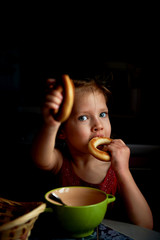 The girl eats soup with the wheel. Appetite