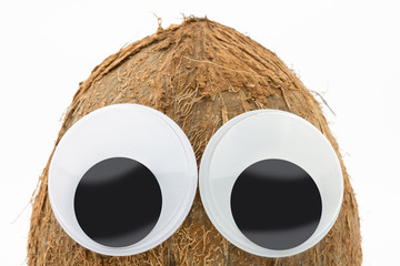 coconut with googly eyes on white background 
