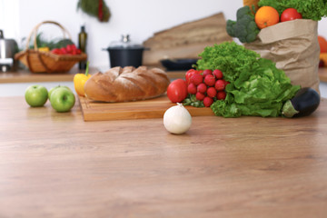 Desk  with many fresh vegetables and fruits in the kitchen. Cooking, vegetarian and shopping concept