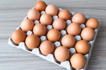 Brown chicken eggs in cardboard box