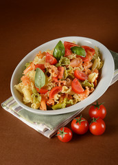Colorful pasta with cherry tomato and basil