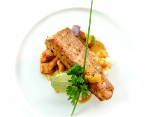 seared fish with risotto on white plate