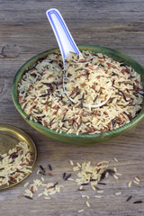 Rice, spoon on old wooden table