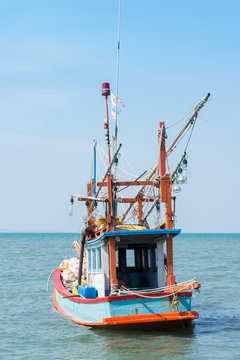 traditional fishing boat at the sea against sunny sky, Thailand