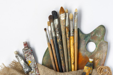 Brushes, palette and tubes with paint
