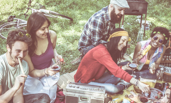 Diverse Group Of Friends Picnic In Park Outdoors In  Sitting On Meadow On  Sunny Day. Faded Vintage Look