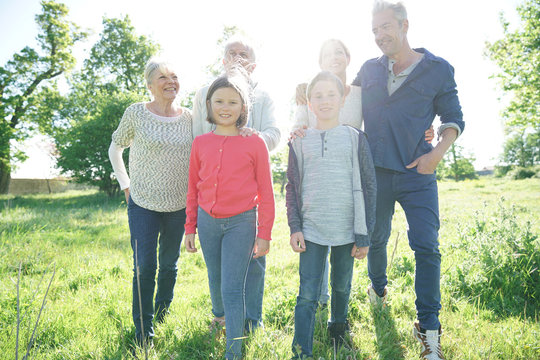 Happy intergenerational family walking in park