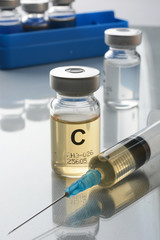 Vaccine in the vial with syringe near