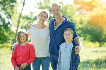 Fototapeta premium Cheerful family walking in park on sunny day
