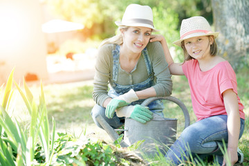 Portrait of mother and daughter gardening together