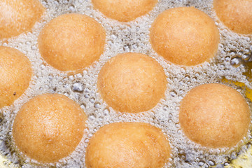 Colombian fritters in cooking process in oil