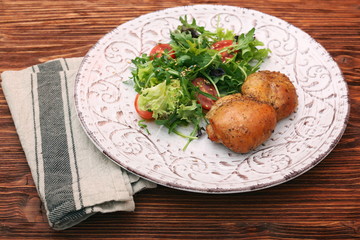 Smoked chicken leg with salad on wooden table
