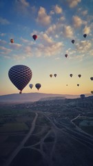 Aerial view of hot air balloons fly over field in Cappadocia, Turkey