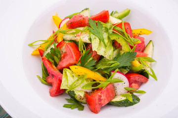 Salad Arab of fresh vegetables with lettuce leaves and parsley, mints with sauce of their garlic, olive oil and juice of a lemon