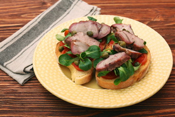 Open sandwich with pork greens and capers