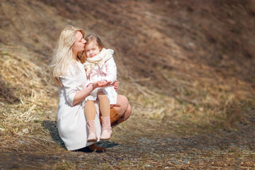 Mom and daughter are walking in the park. Spring. Outdoor. Copy space.