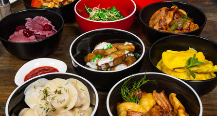 Set of different dumplings and ravioli on a wooden table