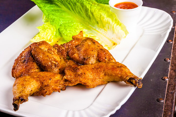 Chicken tabaka on white plate