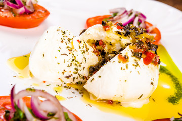 Mozzarella buffalo with dried tomatoes and pesto sauce