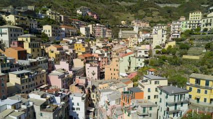 Fototapeta premium Aerial video footage with drone on Riomaggiore, one of the famous Cinqueterre country, small village with colored houses on the cliff over the sea