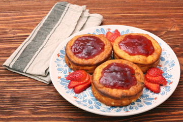 Cottage cheese patties with strawberry jam.