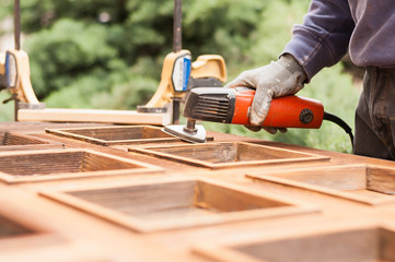 Carpenter at work with angular Sander.