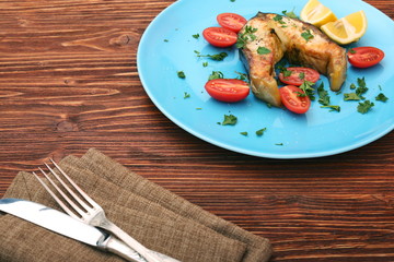 Steak of sturgeon with lemon and tomatoes