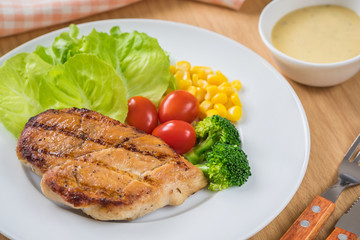 Grilled chicken steak and vegetables on plate
