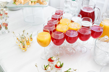 Restaurant Cocktail Tables in the Cocktail party. ice in a transparent glass bowl and metal sticking. festive buffet, alcoholic and alcohol free drinks.