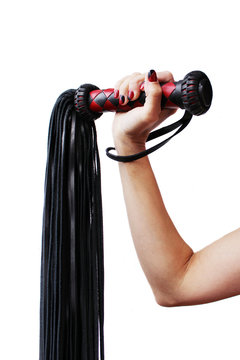 The handle of a red and black lash in a female hand on a white background.