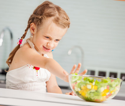 Little girl refuses to eat salad