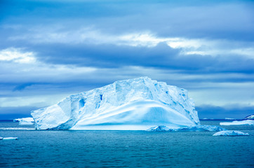 The shapes of icebergs drifting in Paradise Bay, Antarctica, are carved by the sea and winds. - 149424111