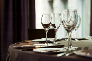 Glasses for wine on the window background, selective focusing