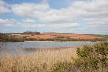 The red fields and freshwater lake at Slapton south Devon England