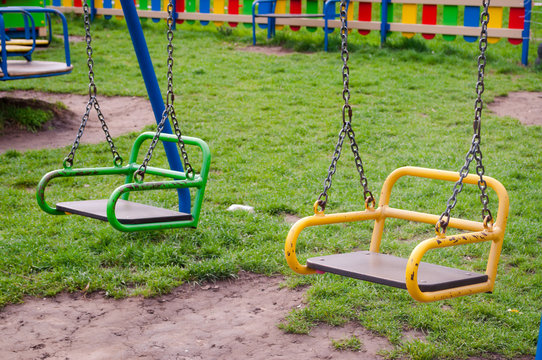 Brightly colored swings on the Playground .