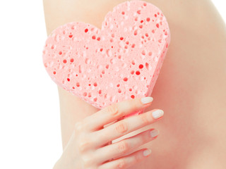 woman holding heart sponge closeup