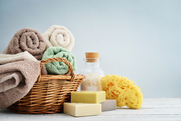 Obraz na płótnie Canvas Bath towels of different colors in wicker basket