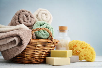 Fototapeta na wymiar Bath towels of different colors in wicker basket