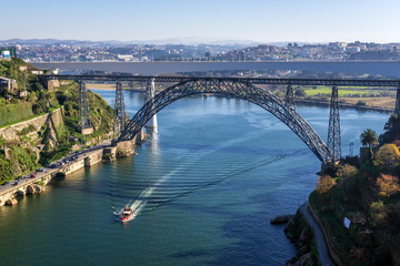 Douro River view with old railway bridge of Maria Pia connected cities of Porto and Vila Nova de Gaia (R), Portugal