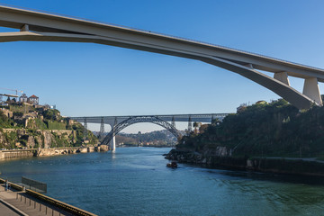 Prince Henry Bridge between cities of Porto and Vila Nova de Gaia, Portugal. Old and new railway bridges on background