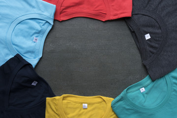 close up of rolled colorful clothes on black background