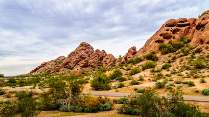 The red sandstone buttes of Papago Park, with its many caves and crevasses caused by erosion under cloudy sky, in the city of Tempe, Arizona in the United States of America