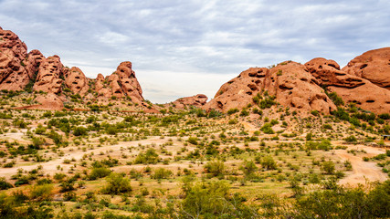 The red sandstone buttes of Papago Park, with its many caves and crevasses caused by erosion under cloudy sky, in the city of Tempe, Arizona in the United States of America