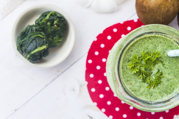 Healthy green smoothie with spinach,kiwi and lemon.