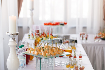 Assorted canape with cheese, meat, rolls, tortilla and fruit salad. Food to accompany the drinks. the buffet at the Banquet. A reason to celebrate the event. Wedding or anniversary