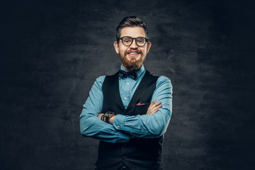 Successful bearded male with crossed arms, dressed in elegant shirt and waistcoat.