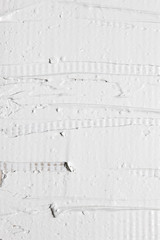 Rough surface, negligent texture of white plaster on the wall, closeup. Putty background, repair, building, interior material design concept